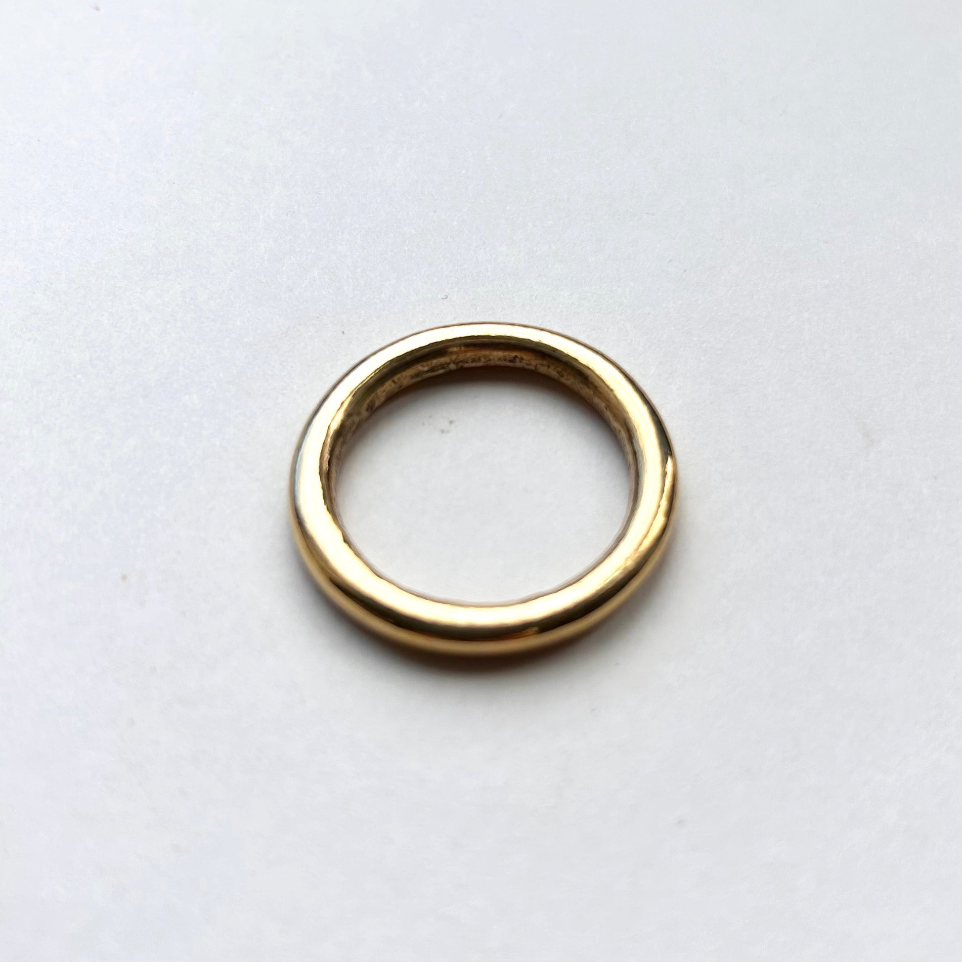 Gold solid brass o ring on a white background