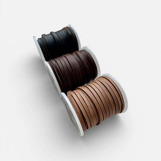 Spools of Horween Leather Thonging Lace Brown, Black and Natural on a white background