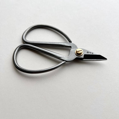 Pair of scissors on a light gray background