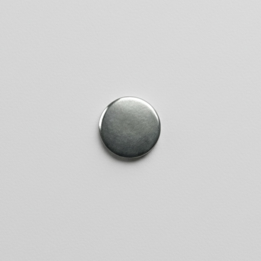 Magnetic button disc fastener on a grey background
