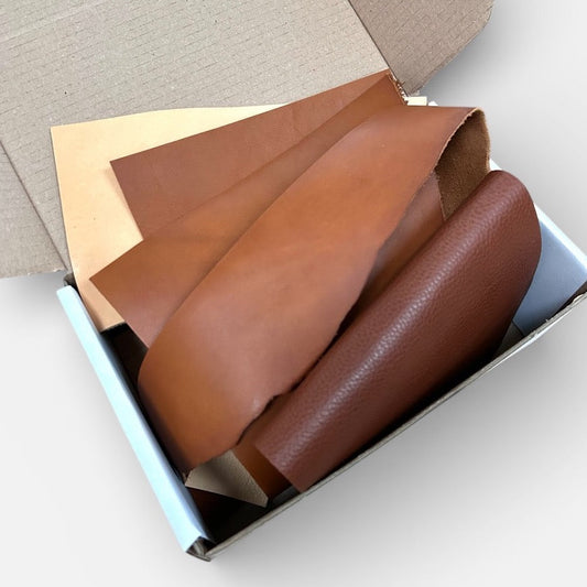 Brown leather samples in a box on a light gray background