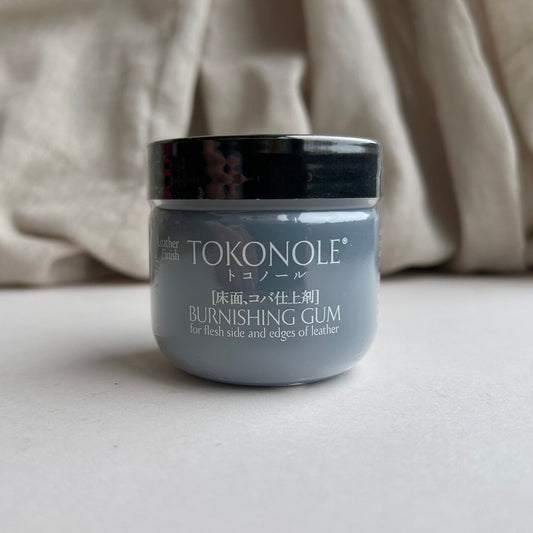 Jar of Tokonole burnishing gum on a neutral background