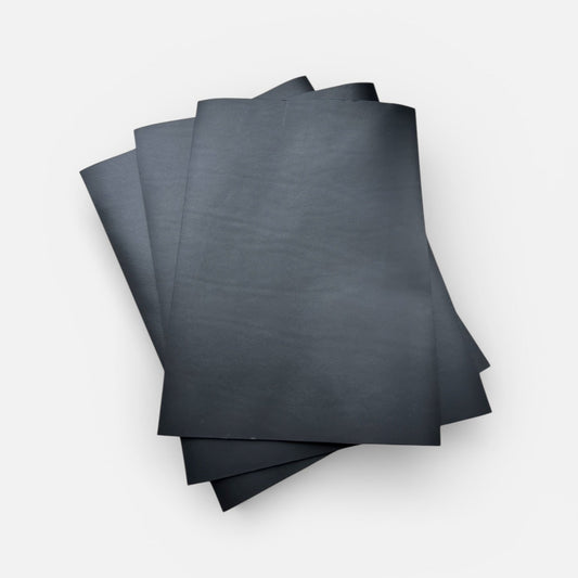 Stack of black leather on a white background