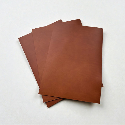 Stack of brown leather pieces on a white background