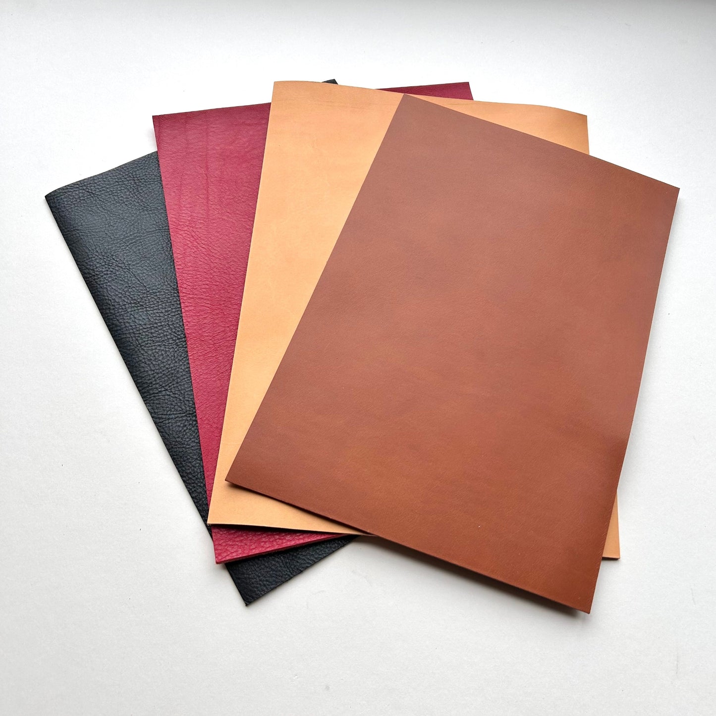 Set of leather panels in various colours on a white background