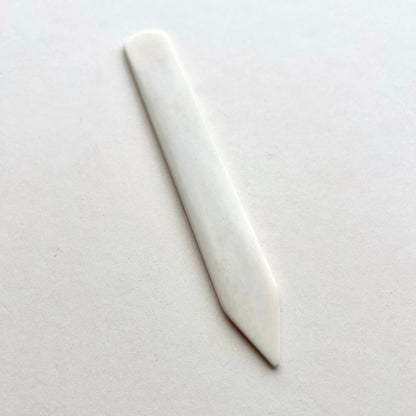 Leather bone creaser tool for folding leather on white background