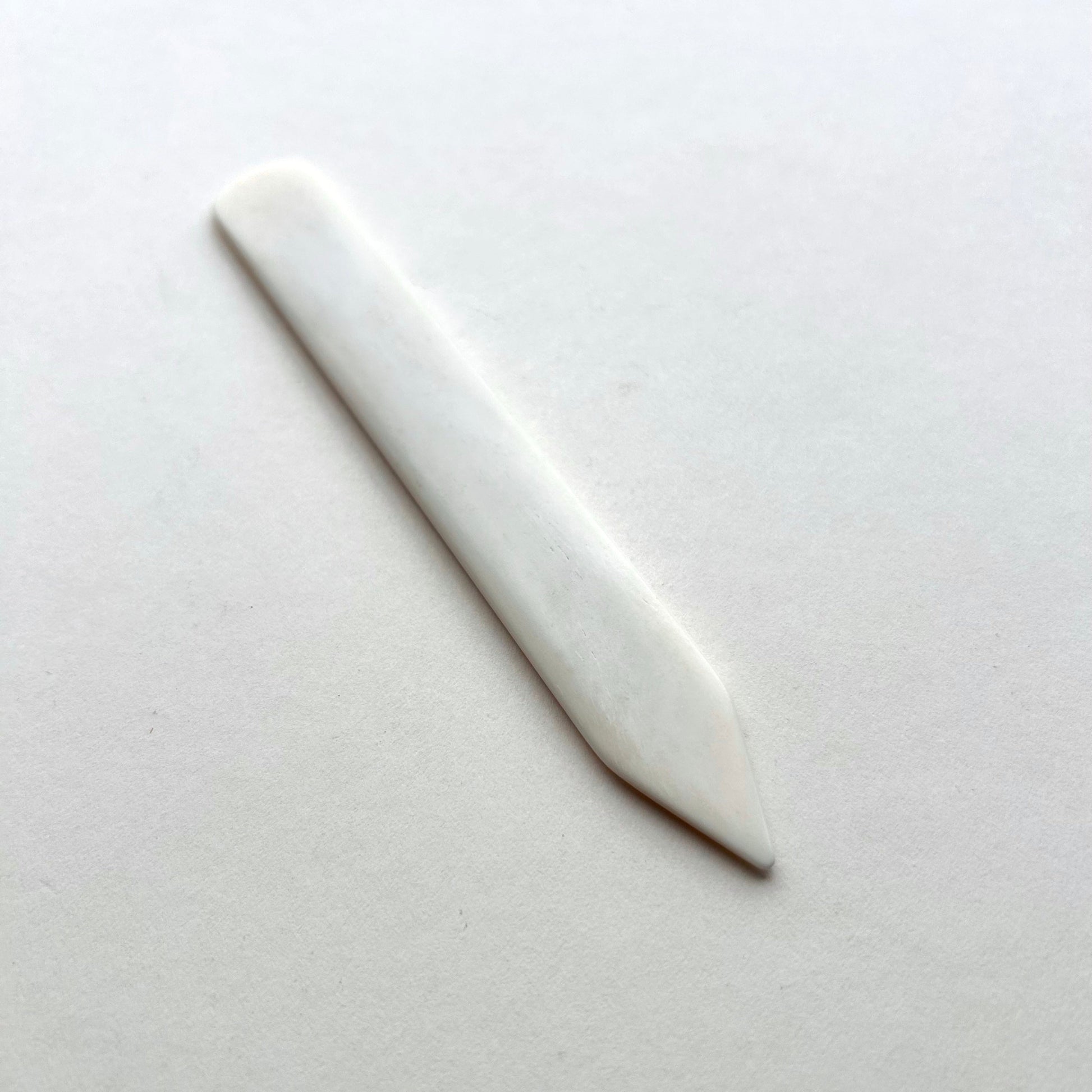 Leather bone creaser tool for folding leather on white background