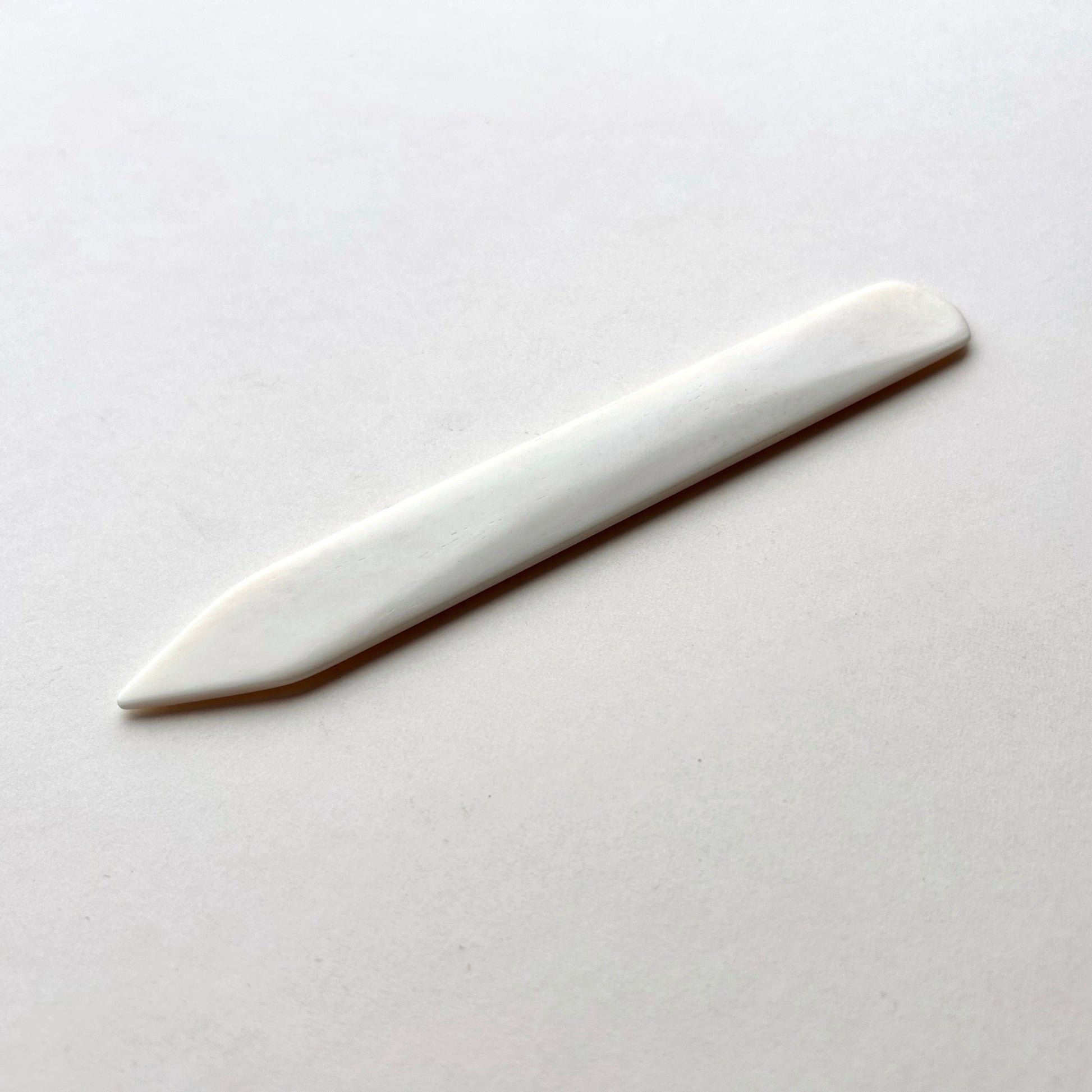Leather bone creaser tool for folding leather on white background