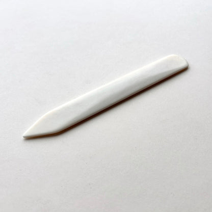 Leather bone creaser tool for folding leather on white background