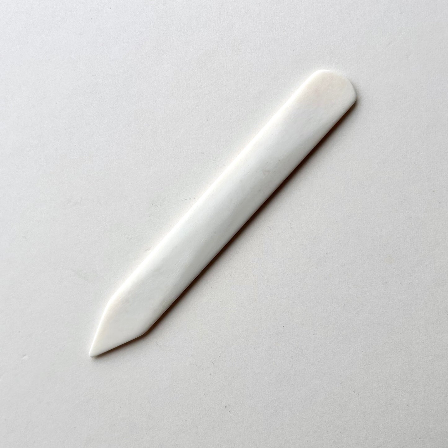 Leather bone creaser tool for folding leather on white background