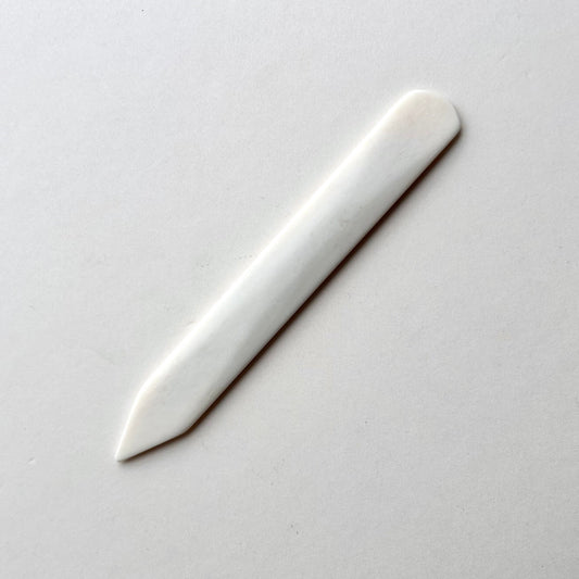 Leather bone creaser tool for folding leather on white background