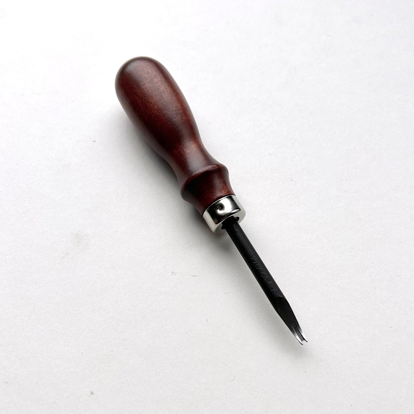 Wooden-handled WUTA leahter edge beveller tool with a metal blade on a white background