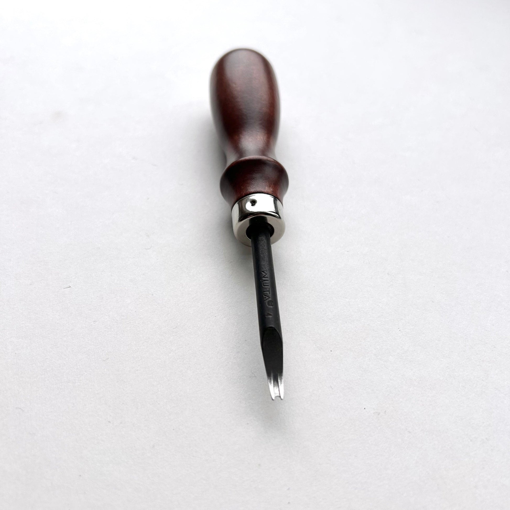 Wooden-handled WUTA leahter edge beveller tool with a metal blade on a white background