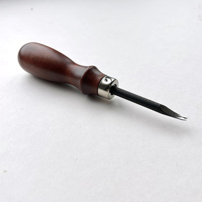 Wooden-handled WUTA leahter edge beveller tool with a metal blade on a white background