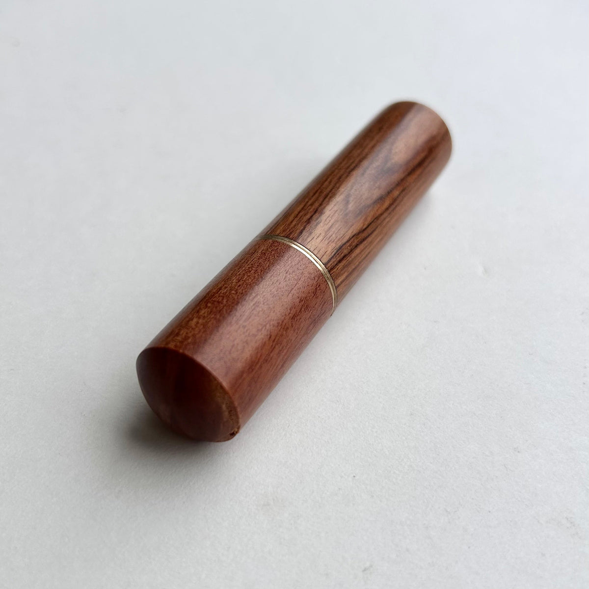 Wooden needle case with brass detail