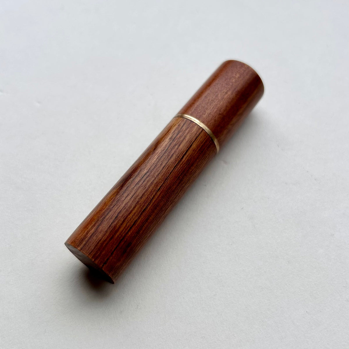 Wooden needle case with brass detail