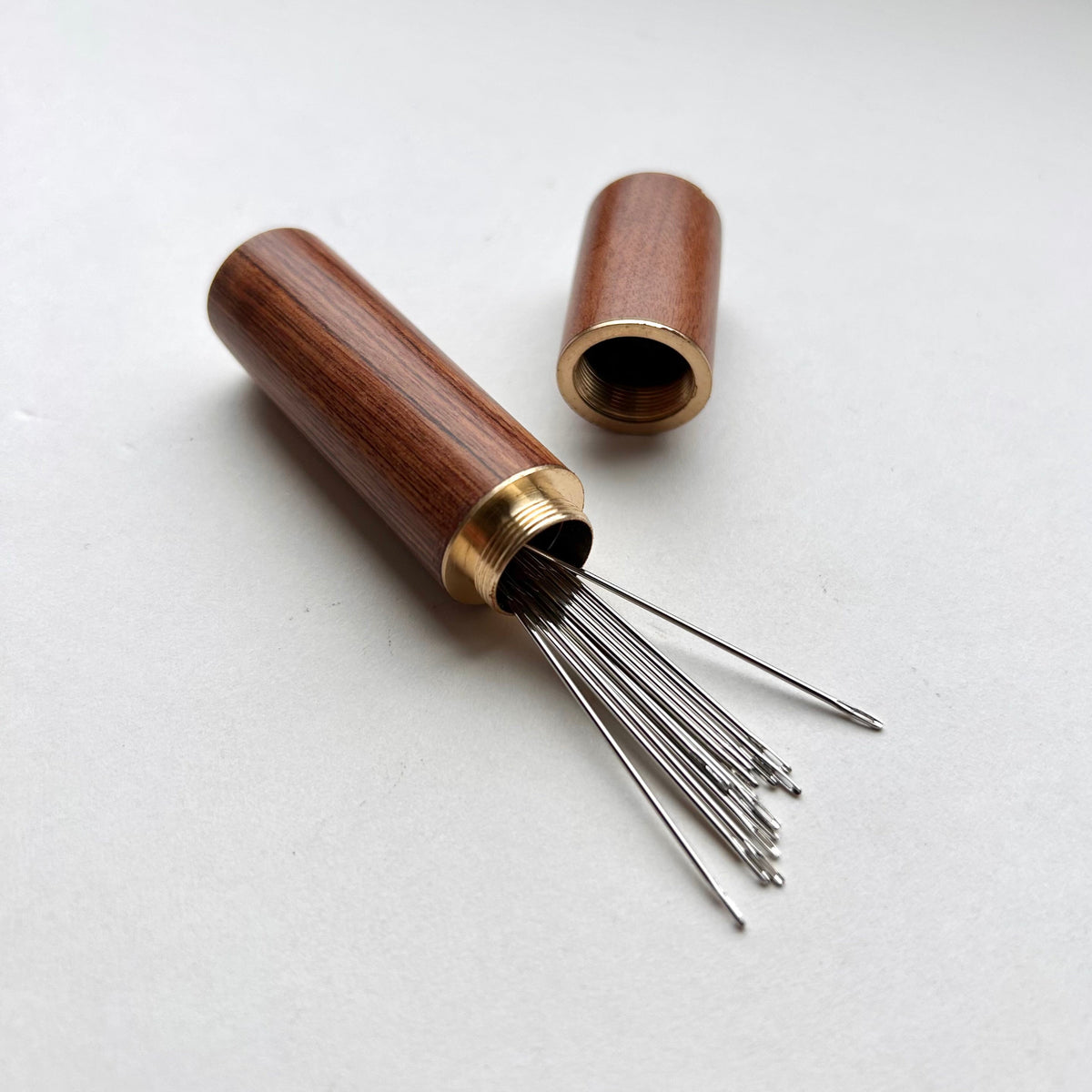 Wooden needle case with brass detail