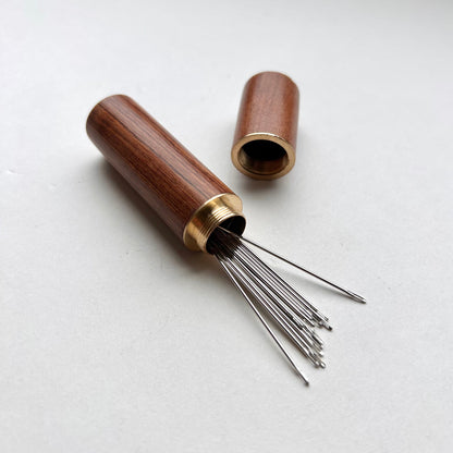 Wooden needle case with brass detail
