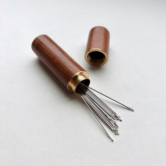 Wooden needle case with brass detail
