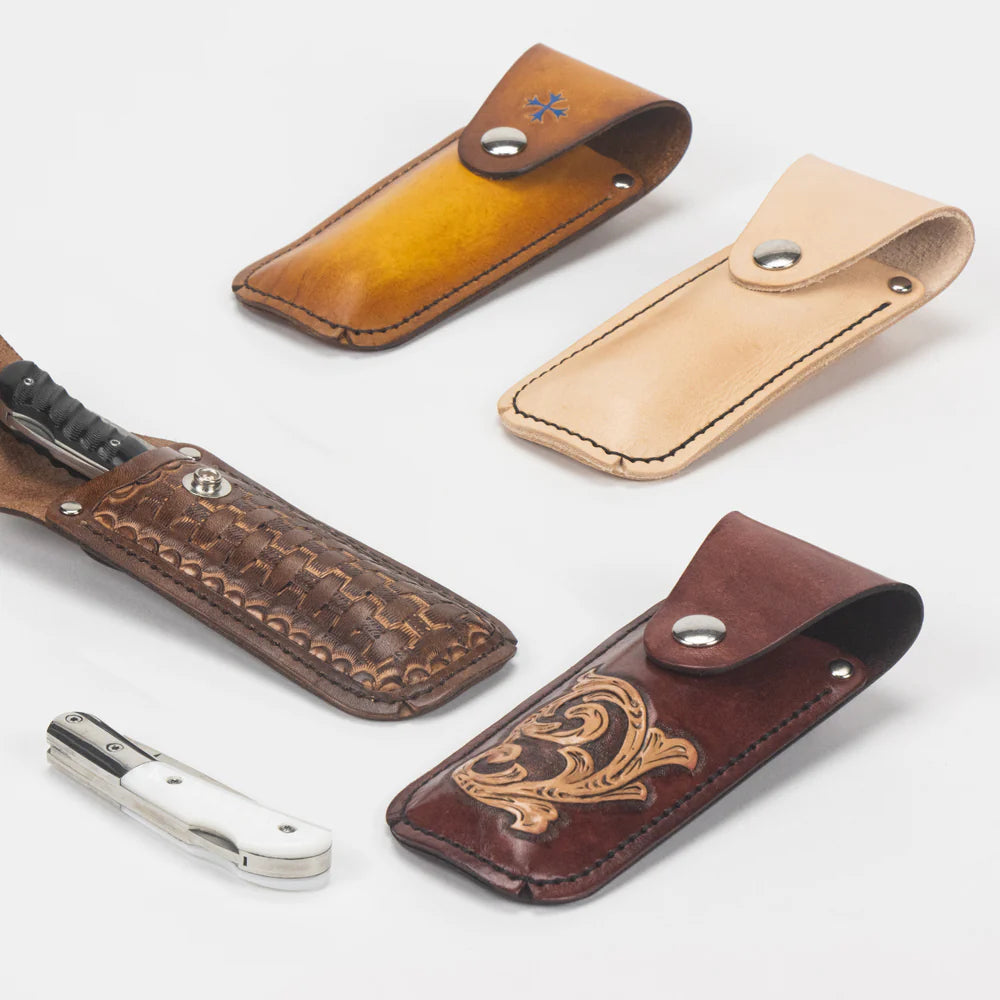 Four leather knife sheaths in different colors on a white background